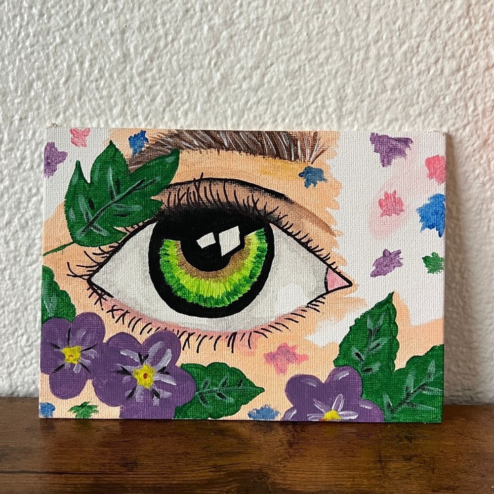 Hand- drawn canvas panel with a green eye inspired.
